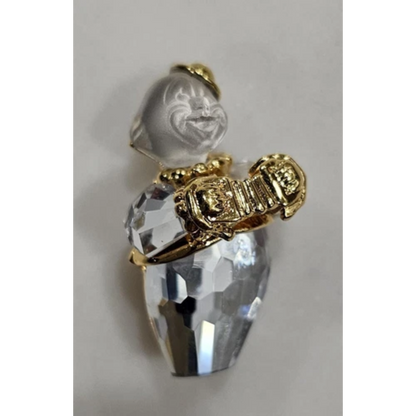 Crystal pendant with gold accents on a light gray background