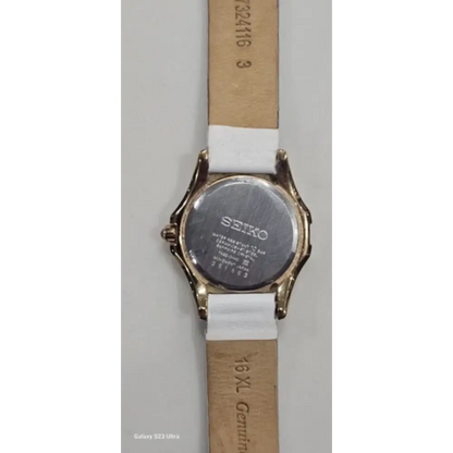 Seiko watch with a white strap on a gray background