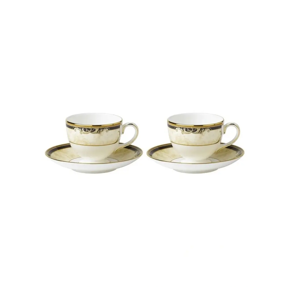 Two white tea cups with gold trim and saucers on a white background