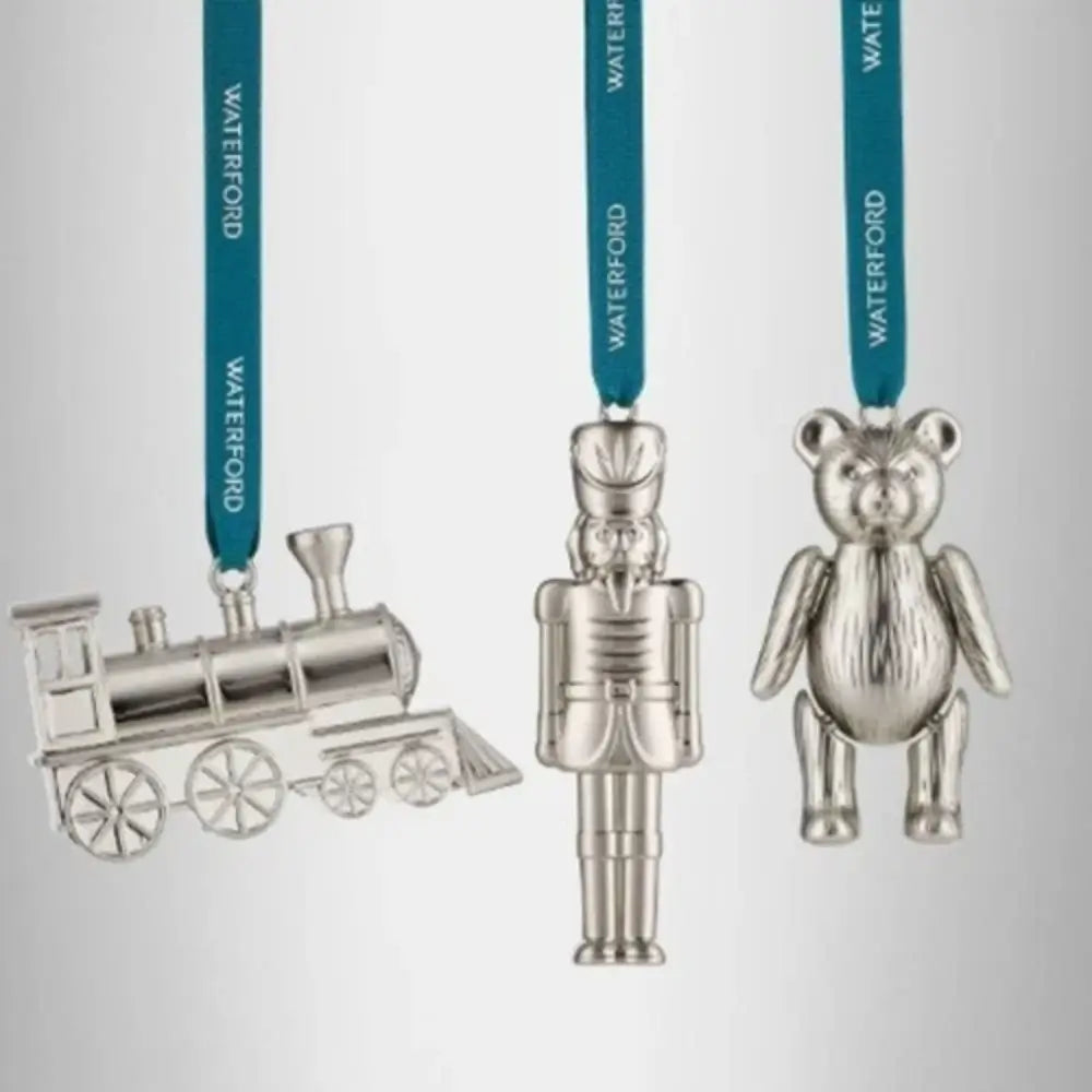 Christmas ornaments shaped like a train, nutcracker, and bear from our home decor