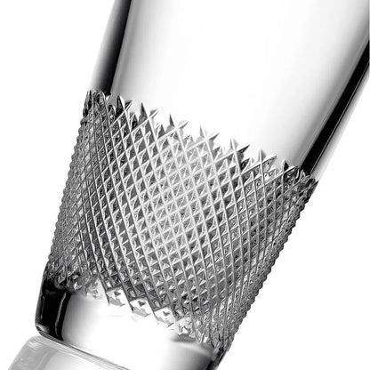 A close-up of a clear glass tumbler with a textured, diamond-cut metallic band around the lower half, set against a clean white background.