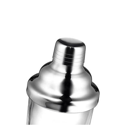 Close-up of a polished stainless steel cocktail shaker top with a reflective metallic finish, set against a plain white background.