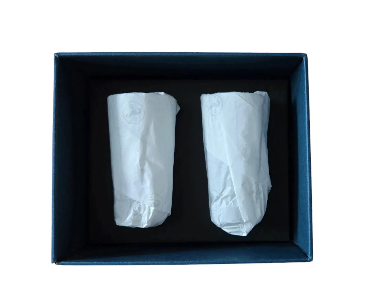Two white cylindrical objects in a blue box on a white background