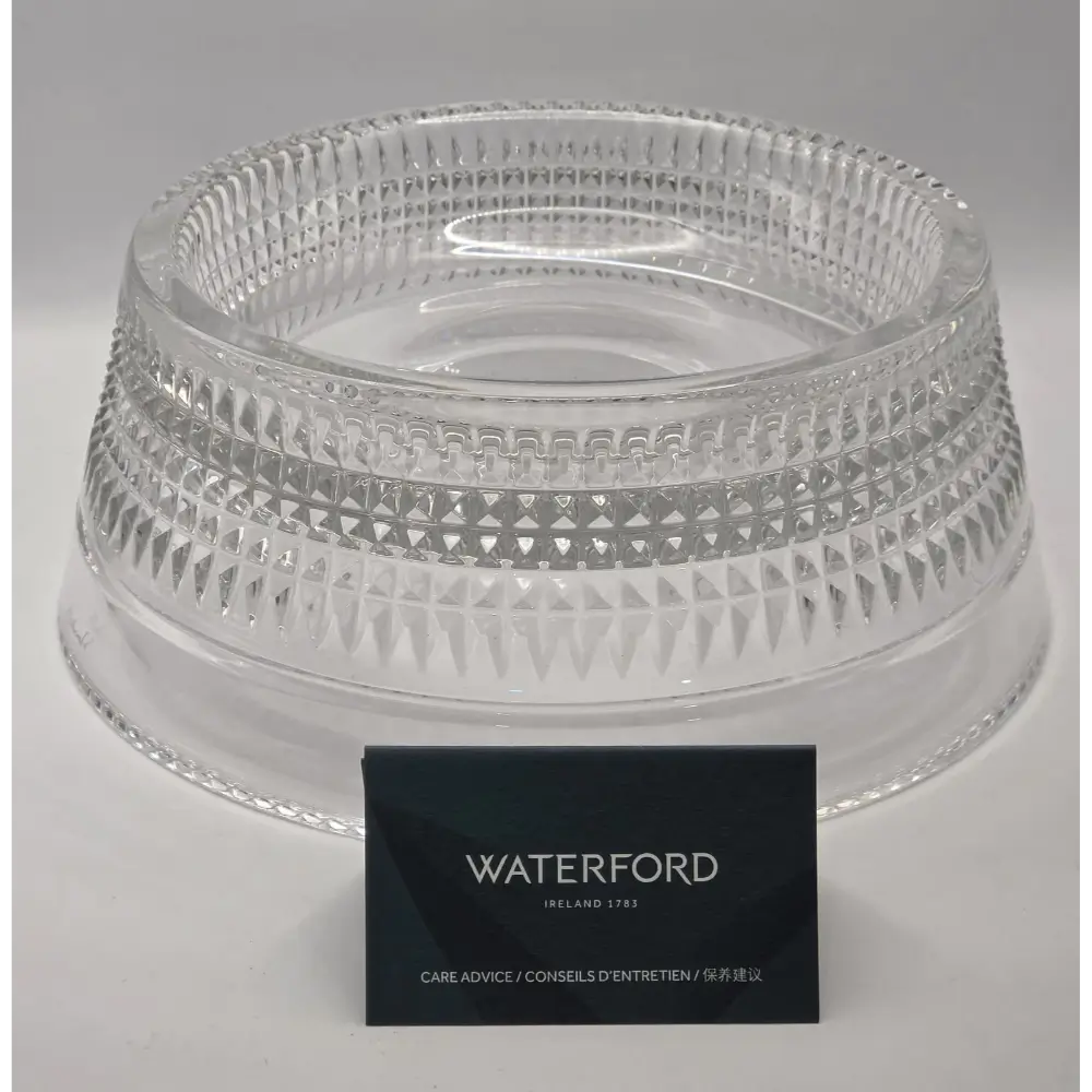Clear glass bowl with intricate patterns on a gray background, featuring the Waterford brand.