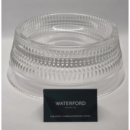 Clear glass bowl with intricate patterns on a gray background, featuring the Waterford brand.