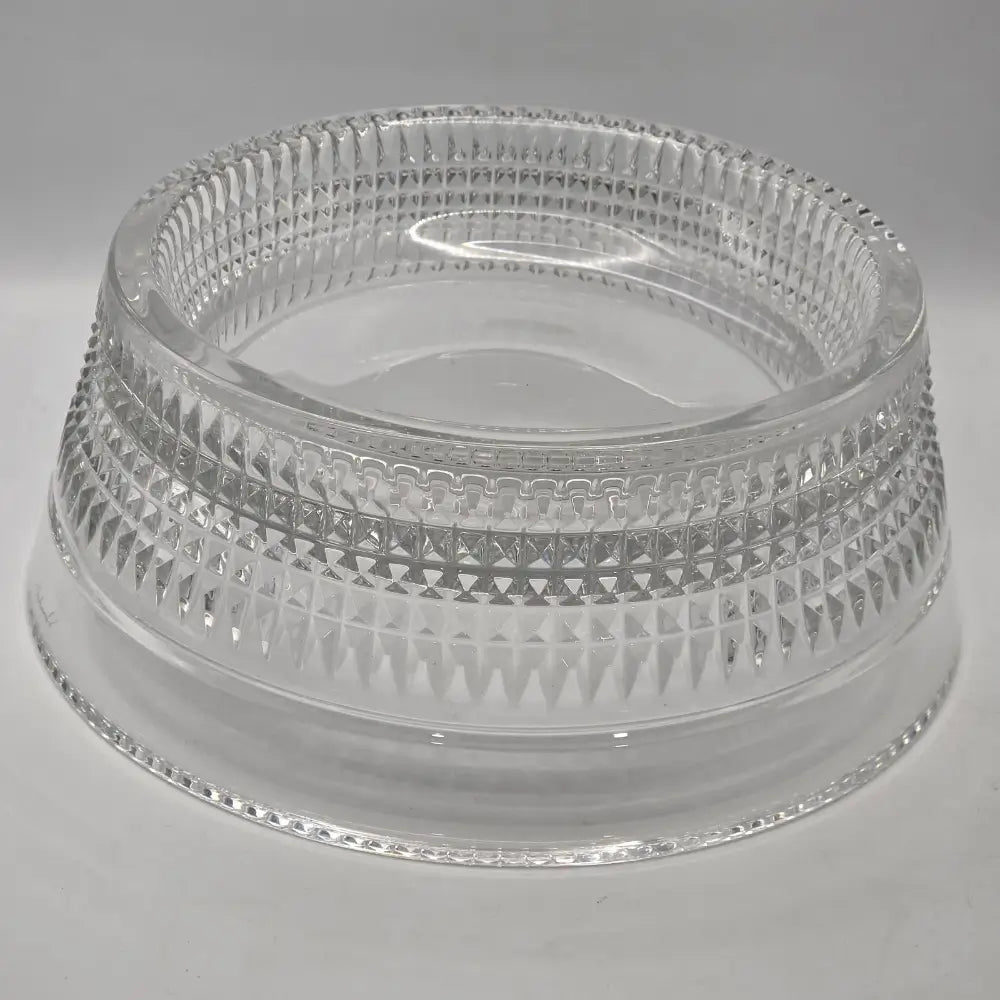 Clear pet bowl with intricate design on a gray background