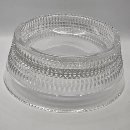Clear pet bowl with intricate design on a gray background