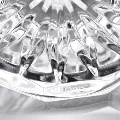 Close-up of a clear glass object with 'Himalayan' branding on a light gray background