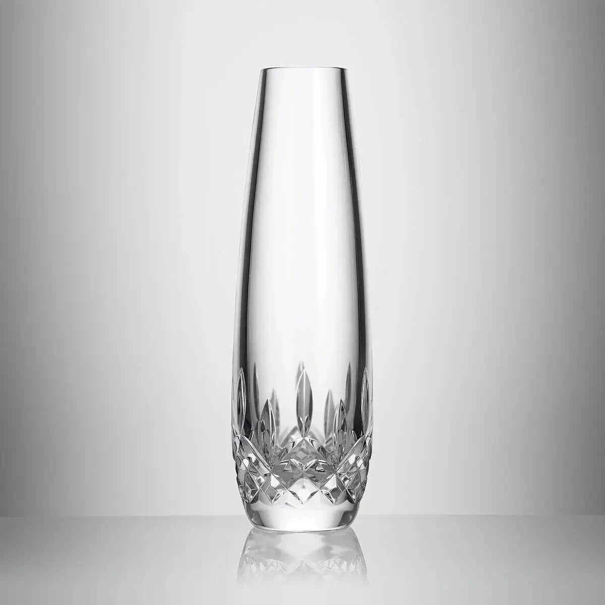 A clear crystal vase with a flared rim and a faceted cut pattern at the base, photographed on a light gray gradient background from our Waterford Crystal Australia collection 