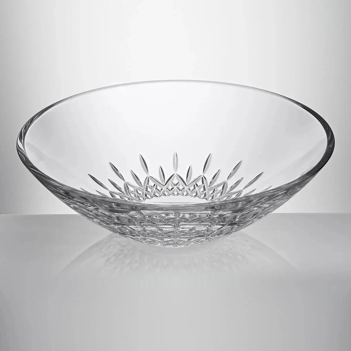 A clear cut-glass bowl with a decorative starburst pattern on the inside and a textured base from our Waterford Crystal Australia collection 