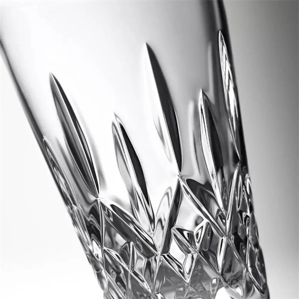 Close-up of a crystal glass with intricate cut patterns on a white background