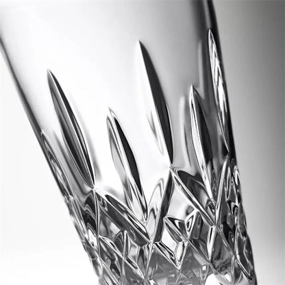 Close-up of a crystal glass with intricate cut patterns on a white background