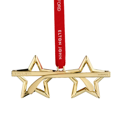 Gold star-shaped ornament with a red ribbon featuring 