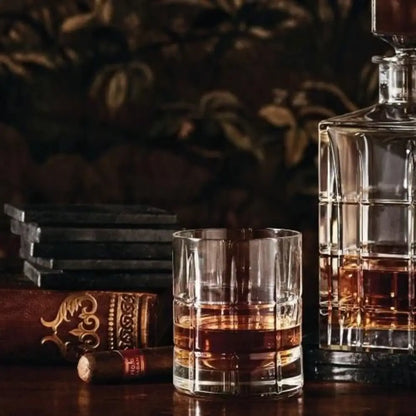 Whiskey glass and bottle with a blurred background