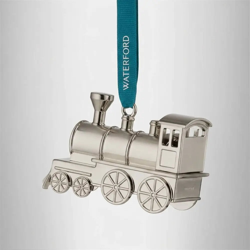 Silver train ornament with a blue ribbon labeled 'Waterford' on a light gray background