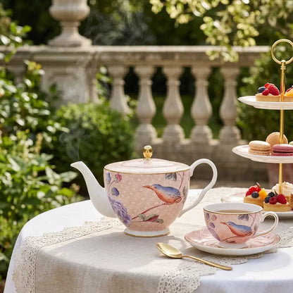 Elegant Wedgwood Paeonia Blush teapot with gold accents in a bright sunlit garden setting.