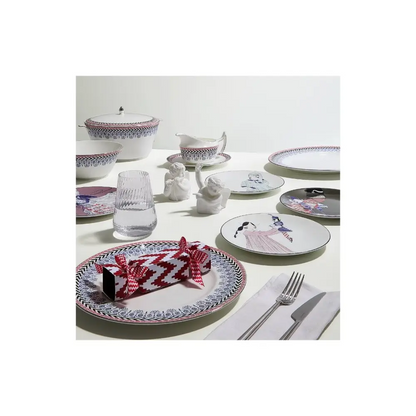 Dining table setting with patterned plates, glasses