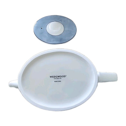 White Wedgwood teapot with a smaller round object