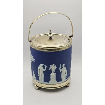 Decorative blue and white container with classical figures on a gray background