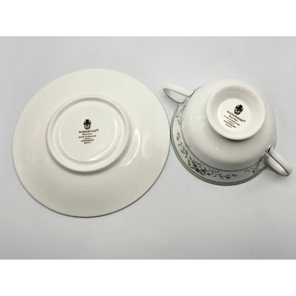 White teacup and saucer with decorative patterns 