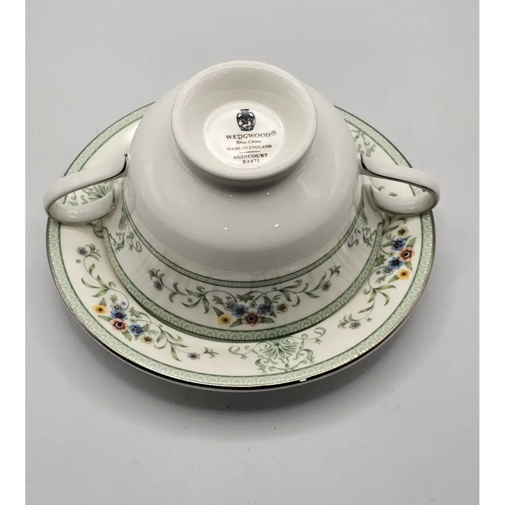 Wedgwood teacup and saucer with floral design on a gray background