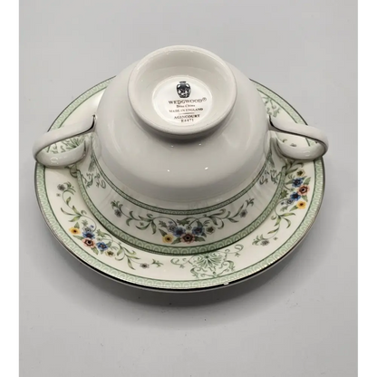 Wedgwood teacup and saucer with floral design on a gray background