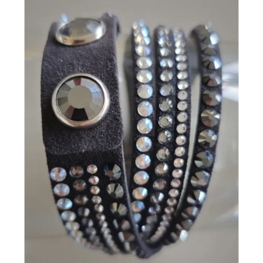 Black leather strap with silver studs and a large silver button