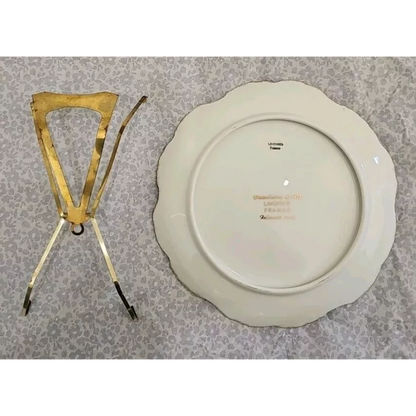White ceramic plate with gold decorative item on a patterned surface