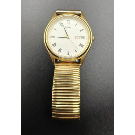 Gold wristwatch with a white face