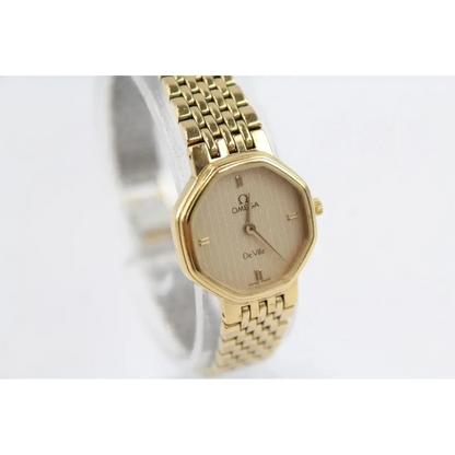 Gold Omega watch on a white background