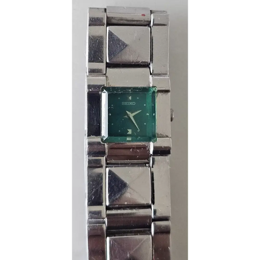 Silver watch with a green face 