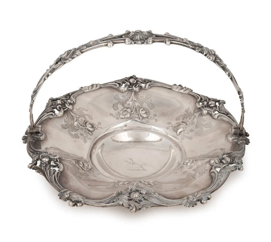 An ornate silver metal basket with a decorative floral handle, photographed on a clean white background from our Antique & Vintage Collectibles Australia collection