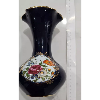 Decorative black vase with floral design and gold accents