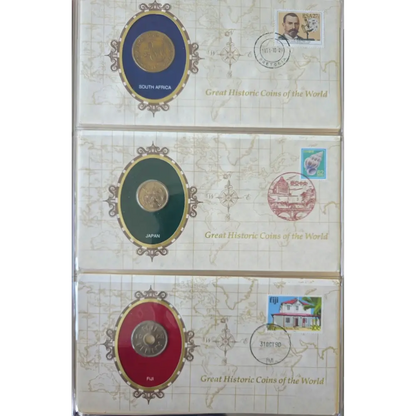 Three collectible coin albums or boxes stacked vertically, each featuring a large oval coin display with a postage stamp and postmark, plus the text 'Great Historic Coins of the World.' The covers are cream with map-style graphics and different coin insert colors: blue, green, and red.