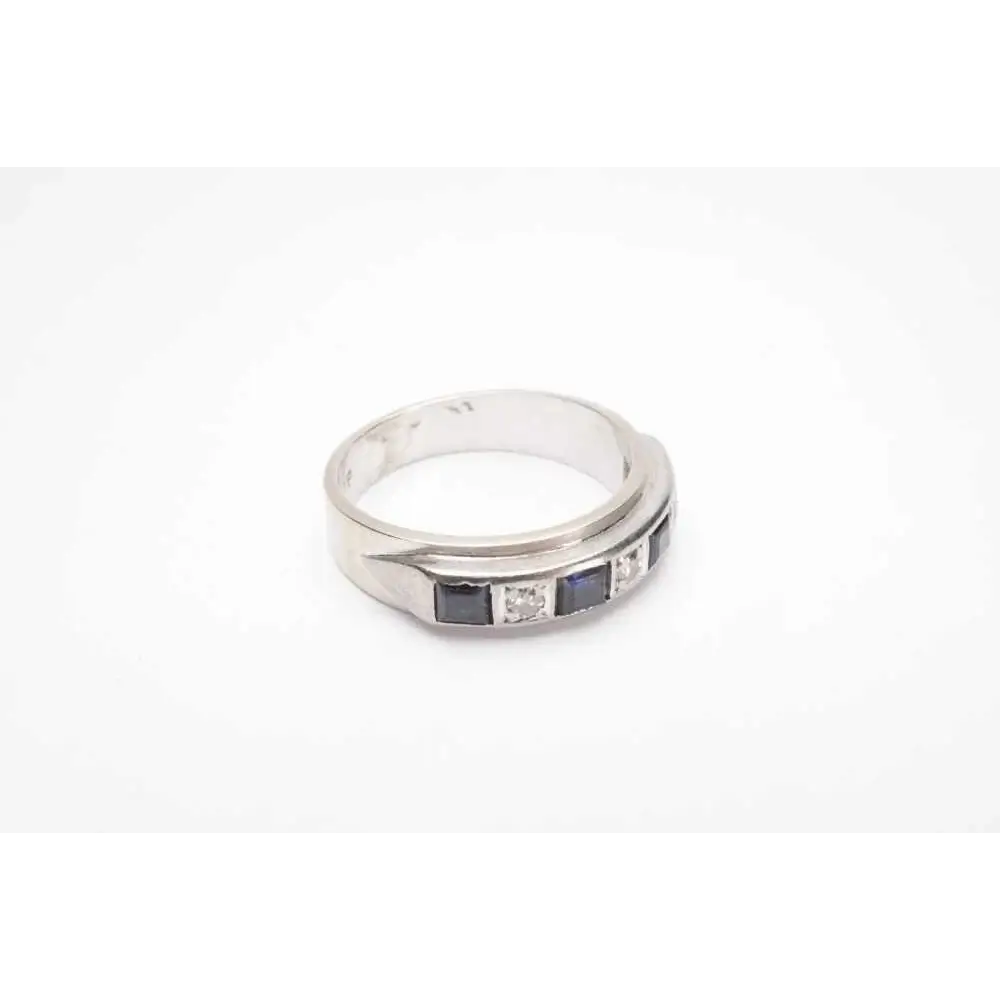 Silver ring with blue gemstone and diamonds on a white background