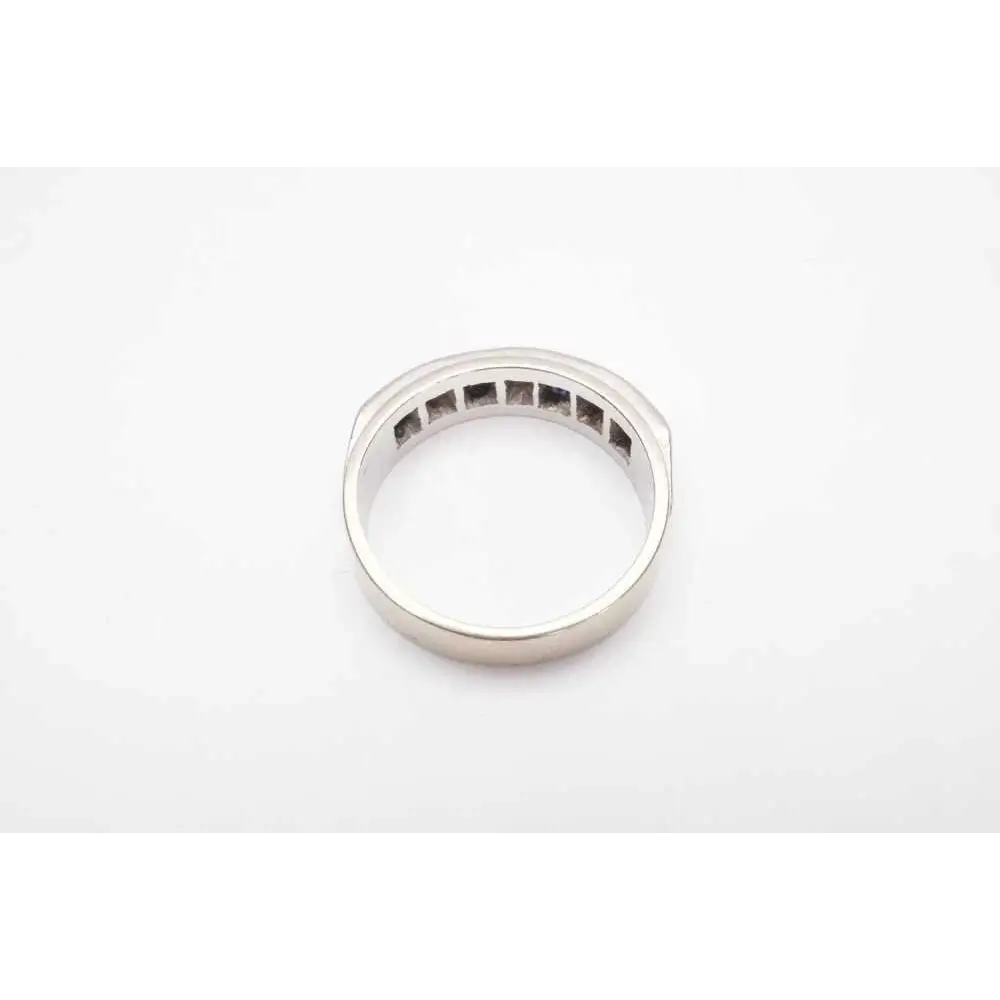 Silver ring with embedded stones on a white background