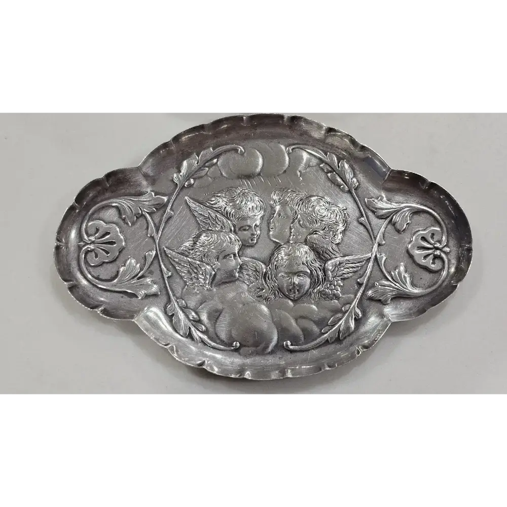 Decorative silver plate with cherubim design on a white background