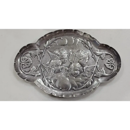 Decorative silver plate with cherubim design on a white background