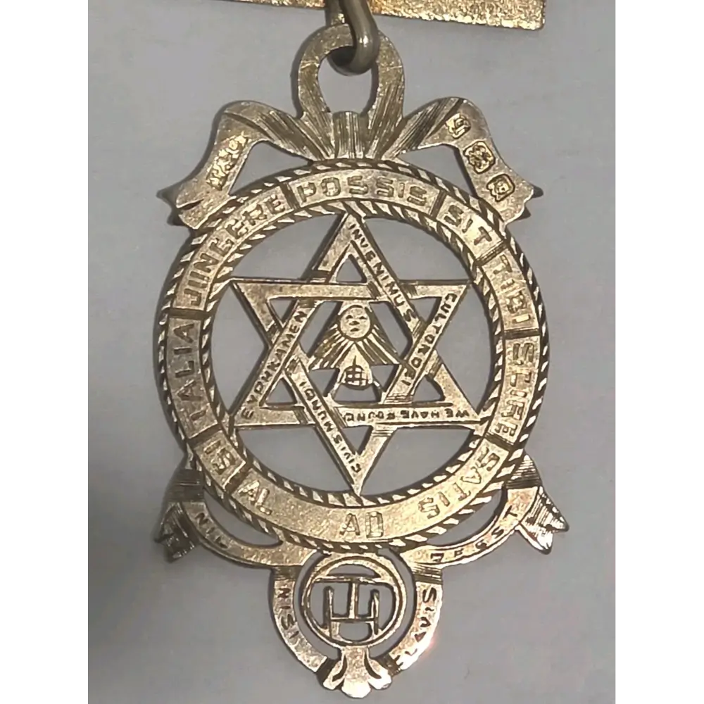 Vintage sterling silver fraternal order medal with star design and gold-toned detailing