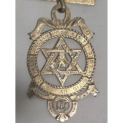 Vintage sterling silver fraternal order medal with star design and gold-toned detailing