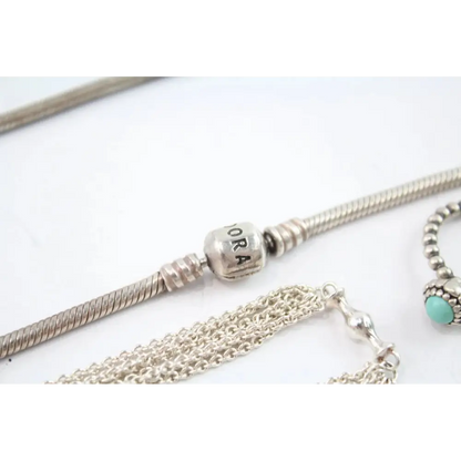 Silver bracelets with charms on a white background