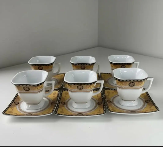 Set of six white ceramic cups and saucers with gold and black patterns from our rea set collection 