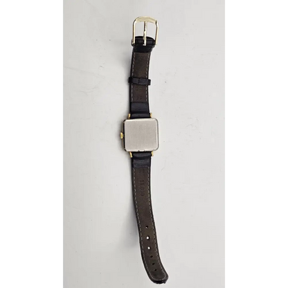 Watch strap with gold buckle on a light gray background