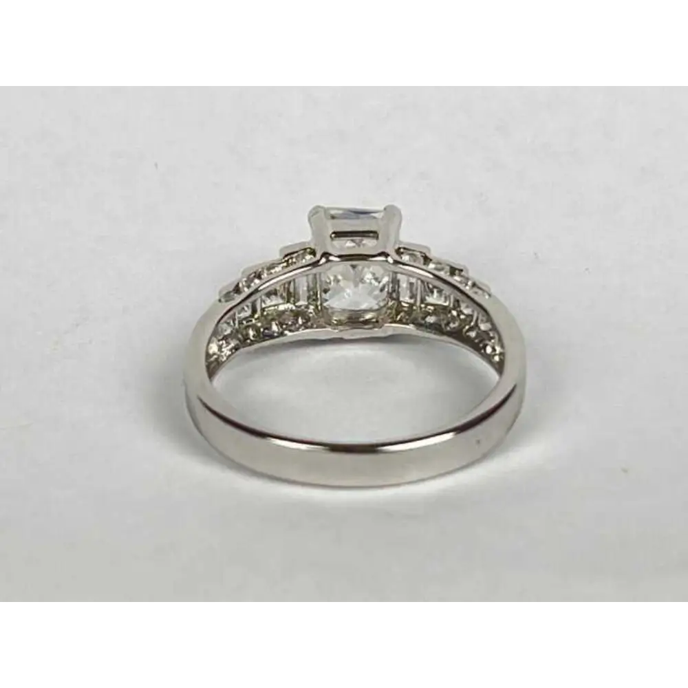 Silver ring with diamond accents on a white background