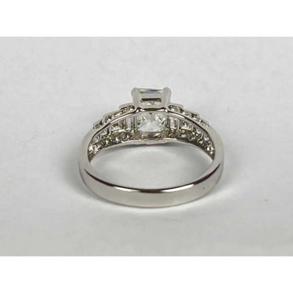 Silver ring with diamond accents on a white background