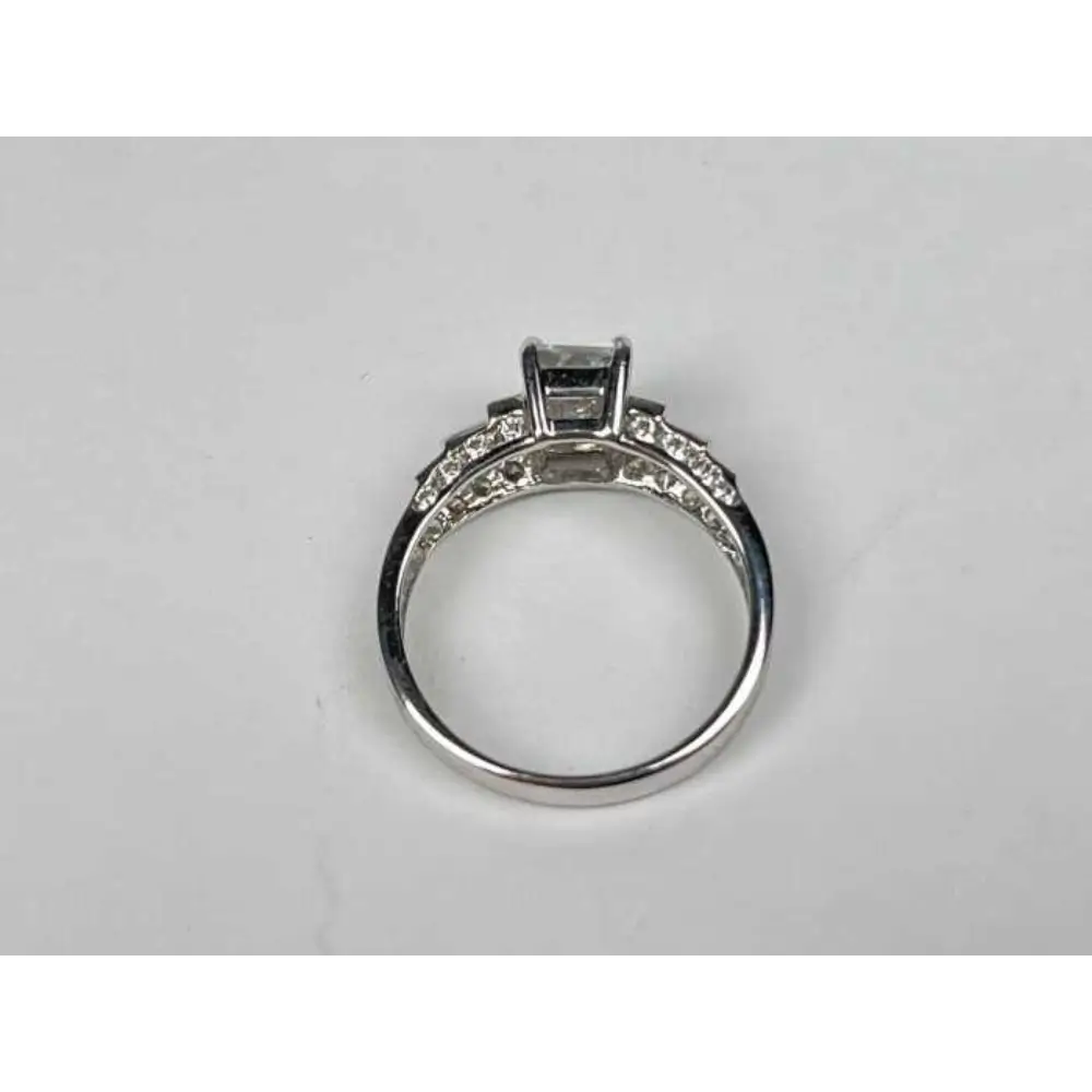 Silver ring with gemstones on a light gray background