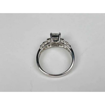 Silver ring with gemstones on a light gray background