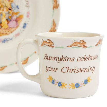 Ceramic mug with 'Bunnykins celebrate your Christening' text and rabbit illustrations.