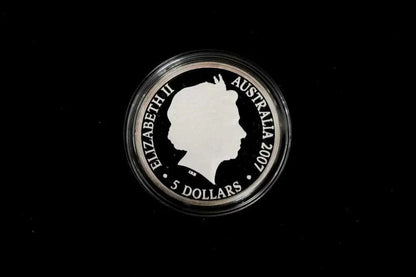 A 2007 Australian 5 dollar coin featuring Queen Elizabeth II's profile, housed in a clear protective capsule against a solid black background.