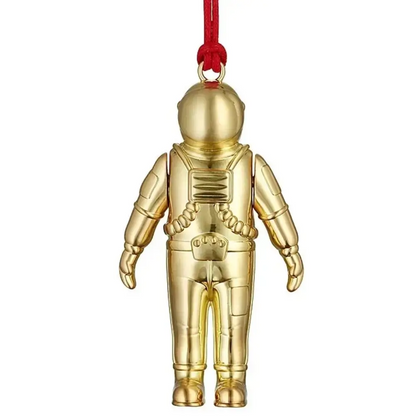 Gold astronaut figurine with a red string 